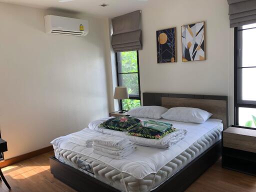 Well-lit bedroom with modern decor and air conditioning