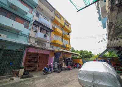 Exterior view of apartment building and parking area