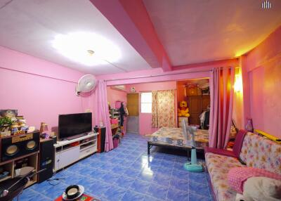 Spacious living room with bright pink walls