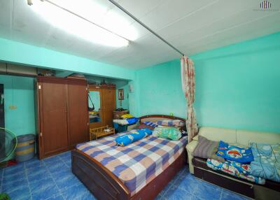 Bedroom with double bed, wardrobe, and sofa