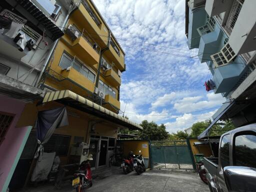 Exterior view of apartment buildings with motorbikes parked outside