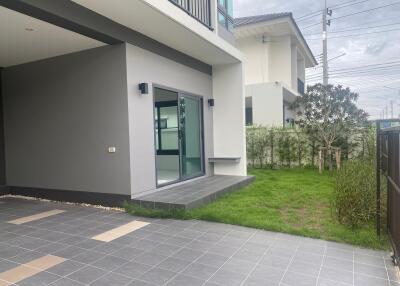 Modern house exterior with lawn and tiled walkway