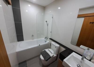 Modern bathroom with bathtub, shower, and sink