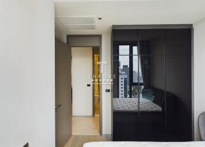 Bright bedroom with large wardrobe and city view