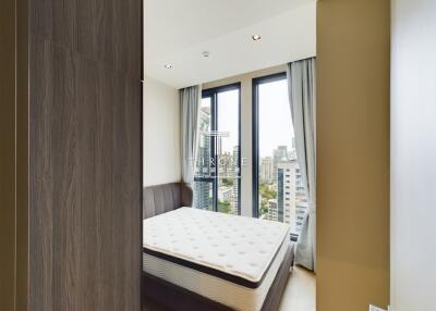 modern bedroom with large windows and city view