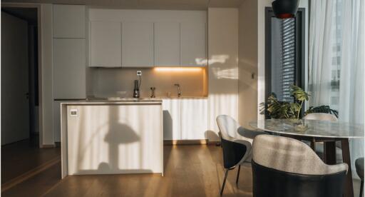 Modern kitchen with dining area and natural light