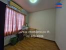 Bedroom with window, air conditioning unit, curtain, and some furniture