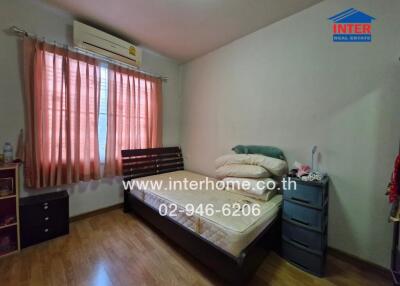 Bedroom with bed, window, and air conditioning unit