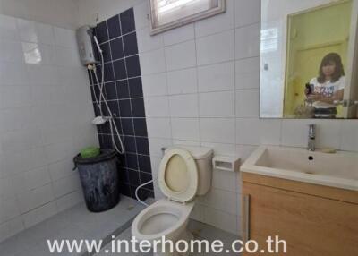 Bathroom with toilet, sink, and shower