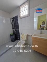 Bathroom with toilet, sink, and shower