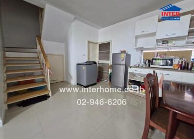 Kitchen and dining area with appliances and staircase