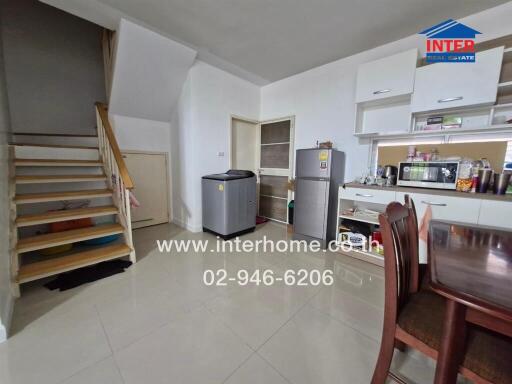 Kitchen and dining area with appliances and staircase