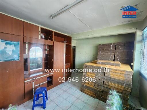 Bedroom with wooden cabinets and stacked mattresses