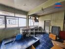 Old kitchen with blue tiled floor and large windows