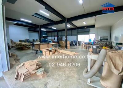 spacious workshop area with equipment and materials