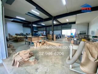 spacious workshop area with equipment and materials