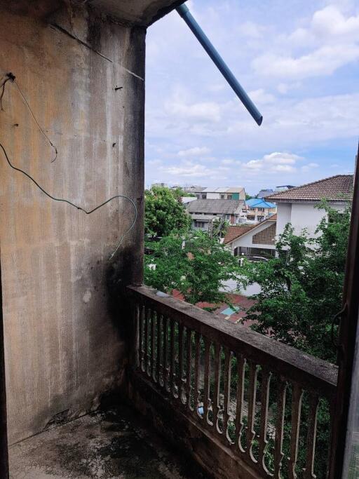 Outdoor balcony with a view of neighboring houses and greenery