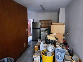 A cluttered storage room filled with various household items.