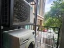 Laundry area with a washing machine and outdoor view