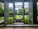 Modern building entrance with water feature and greenery