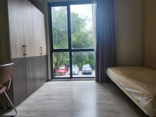 Modern bedroom with large window and wardrobe