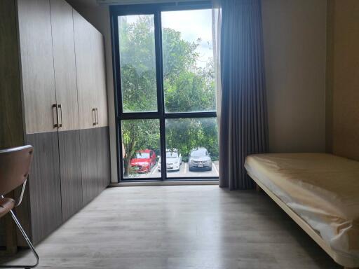 Modern bedroom with large window and wardrobe