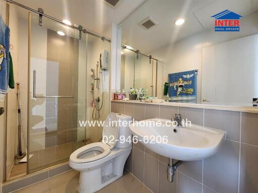 Modern bathroom with shower, sink, and toilet