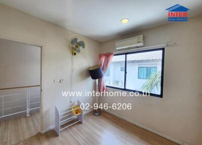 Bedroom with a window, air conditioner, fan, and some decor items