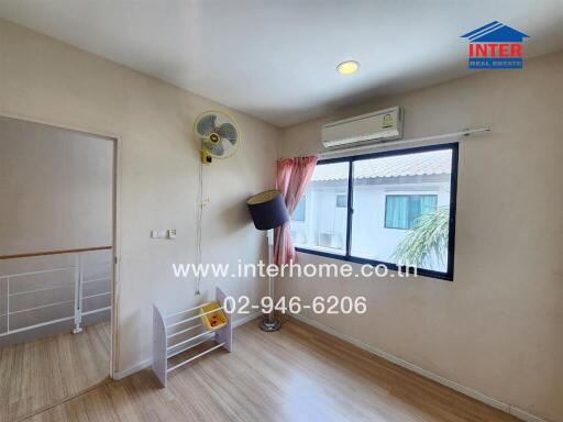 Bedroom with a window, air conditioner, fan, and some decor items