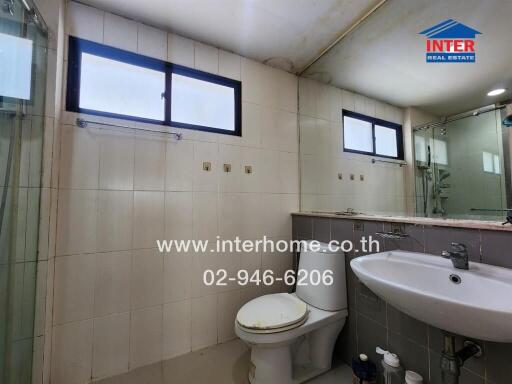 Modern bathroom with sink, toilet, mirror, and glass shower enclosure