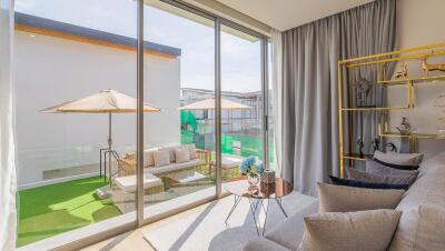 Modern living room with large windows leading to terrace