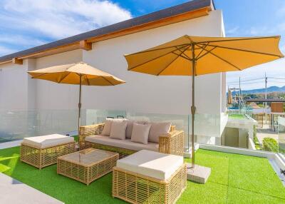 Modern outdoor terrace with wicker furniture and parasols