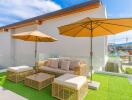 Modern outdoor terrace with wicker furniture and parasols