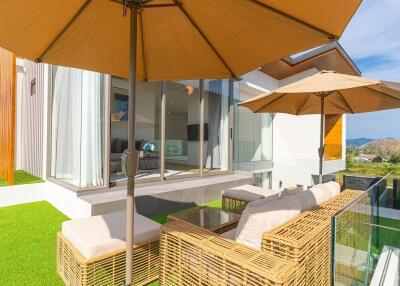Modern outdoor seating area with wicker furniture and parasols