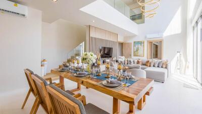 Modern living room with dining area, wooden furniture, and large windows