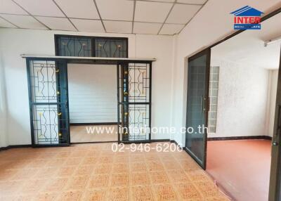 Living room with sliding glass doors and patterned tile floor