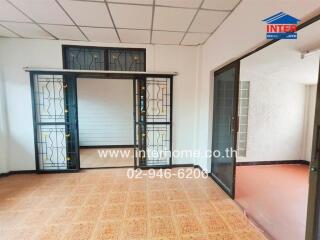 Living room with sliding glass doors and patterned tile floor