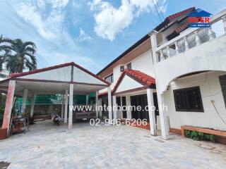 Front exterior view of the house with carport and driveway