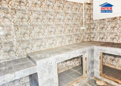 Unfurnished kitchen with tiled walls