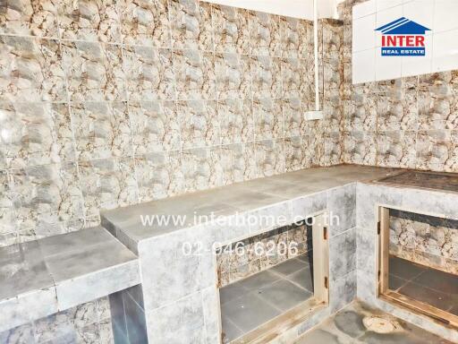 Unfurnished kitchen with tiled walls