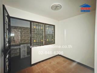 Empty room with barred windows and stained floor tiles