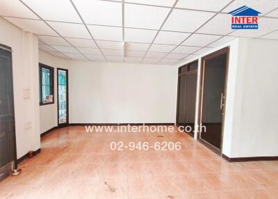 Spacious main living area with tiled flooring and large windows