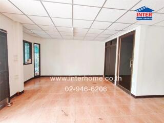 Spacious main living area with tiled flooring and large windows