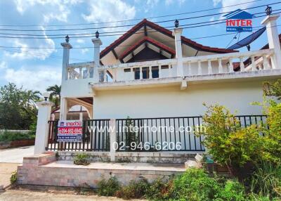 Exterior view of a house with a balcony and overhanging roof