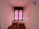 Staircase landing area with dark wooden floors and window shades