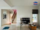 Spacious living room with staircase and TV setup