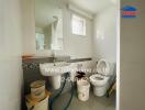 Bathroom with sanitary fixtures and cleaning supplies