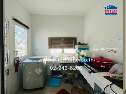 Laundry room with washing machine and countertop