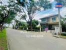 Exterior view of a residential street with houses and greenery