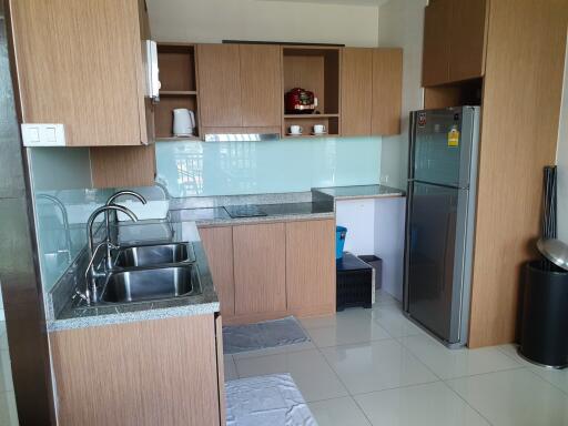 Modern kitchen with wooden cabinets, sink, and appliances